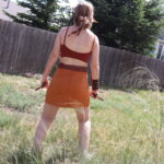 raw picture of model standing in a backyard with grass